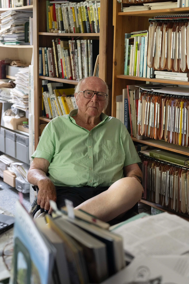 Portrait d'un homme âgé assis dans une bibliothèque